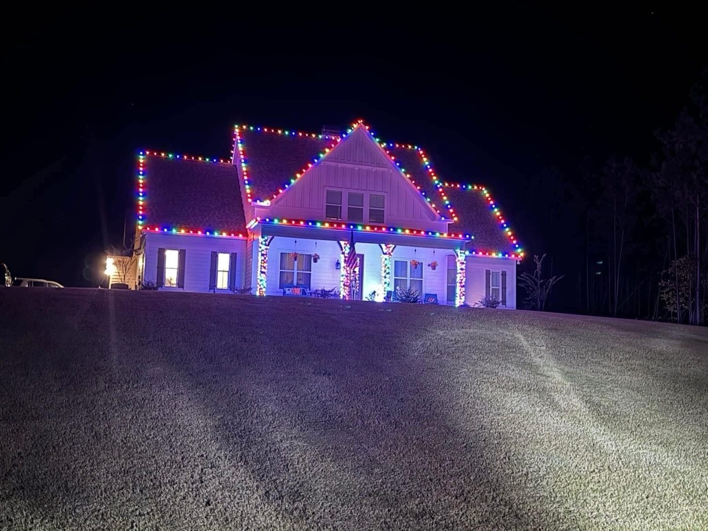 Hilltop home in multicolor lights