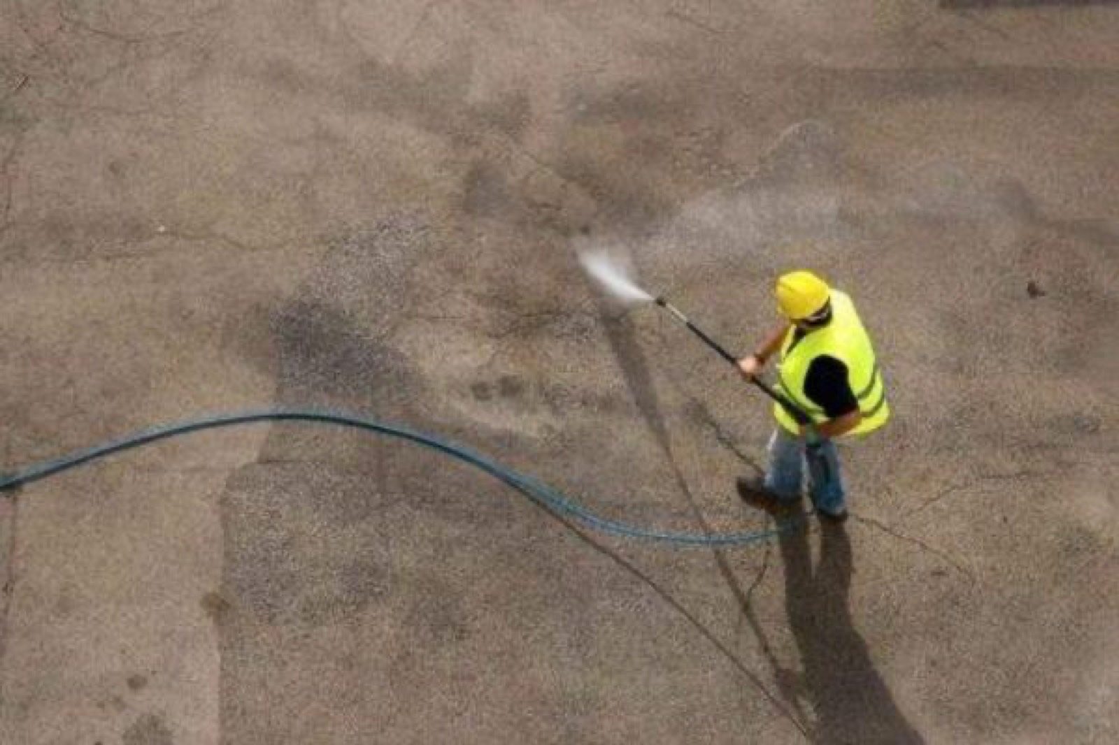 Aerial view of concrete being pressure washed