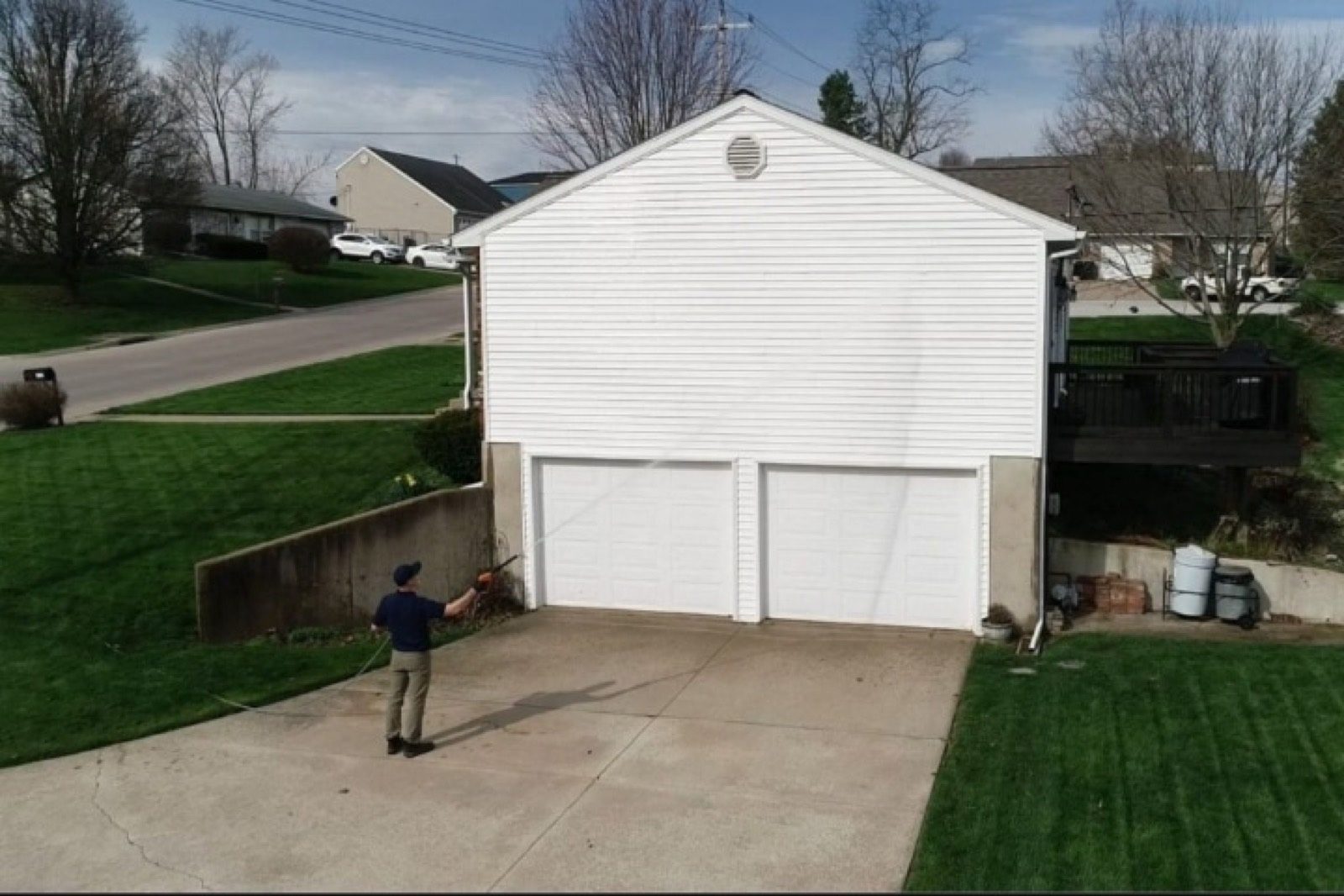 Restore crew washing a home and driveway